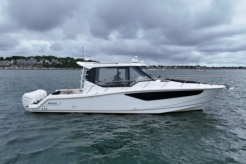  Yacht Photos Pics 2021 Boston Whaler 405 Conquest boat on water under cloudy sky.