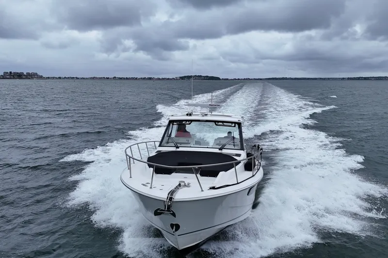  Yacht Photos Pics 2021 Boston Whaler 405 Conquest cruising on open water under cloudy skies.