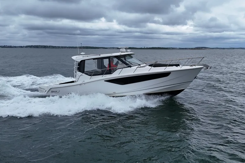  Yacht Photos Pics Boston Whaler 405 Conquest 2021 cruising on open water under cloudy skies.