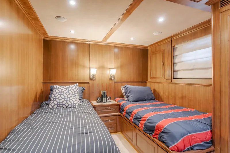 Harley G Yacht Photos Pics Luxurious twin bedroom on 2014 TransWorld 116' yacht with wood paneling and cozy bedding.