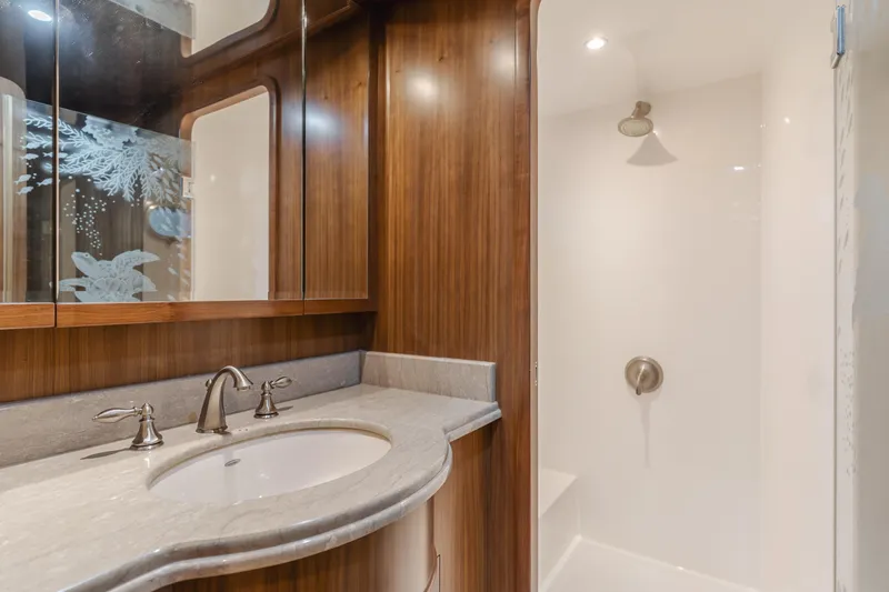 Harley G Yacht Photos Pics Luxurious bathroom with wooden cabinetry and modern shower in 2014 TransWorld 116' yacht.