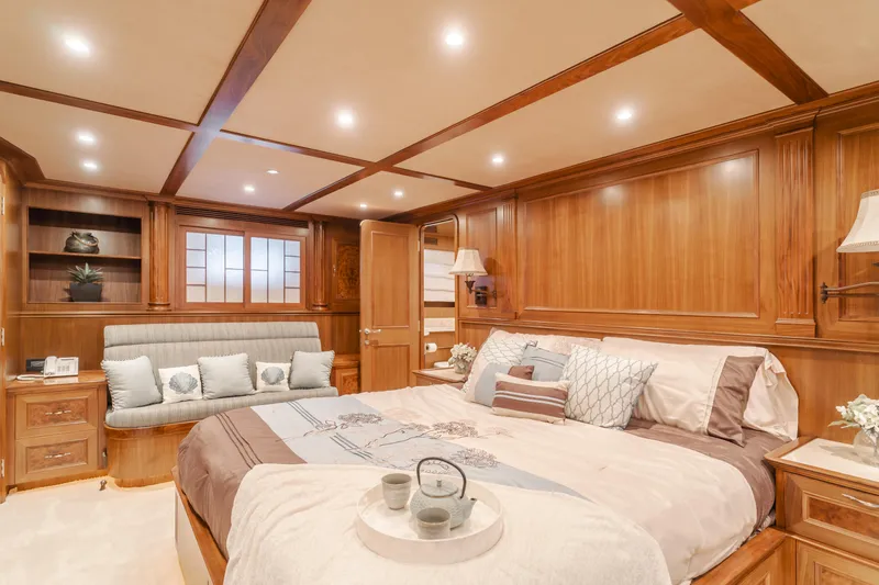 Harley G Yacht Photos Pics Luxurious bedroom interior on 2014 TransWorld 116' yacht, featuring elegant wood paneling and cozy decor.