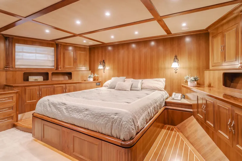 Harley G Yacht Photos Pics Luxurious wooden bedroom interior on 2014 TransWorld 116' yacht, featuring elegant lighting and cabinetry.