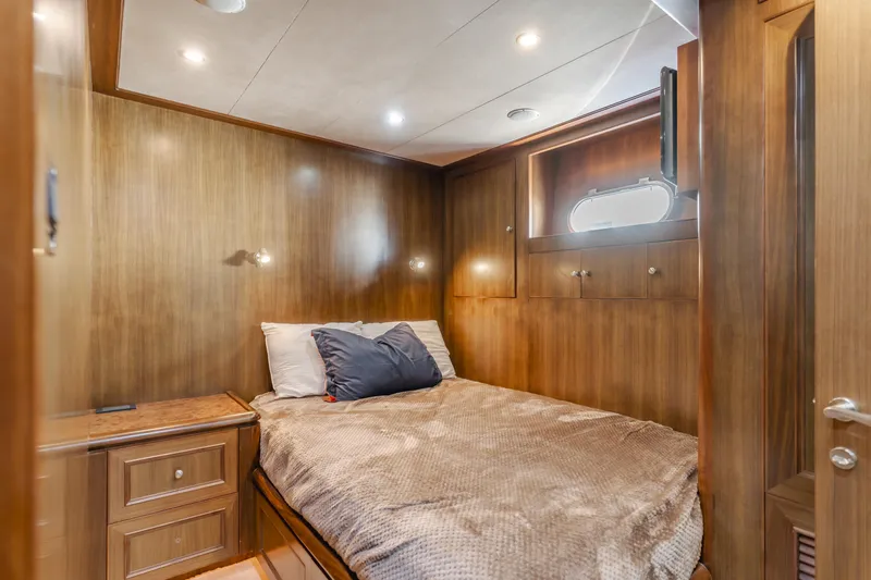 Harley G Yacht Photos Pics Luxurious cabin interior of 2014 TransWorld 116' yacht with cozy bed and wooden decor.