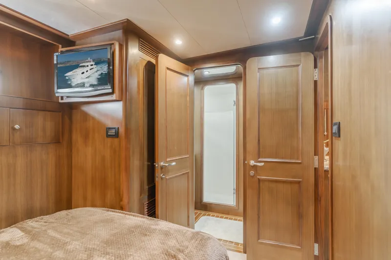 Harley G Yacht Photos Pics Luxurious wooden interior of 2014 TransWorld 116' yacht cabin with TV and ensuite bathroom.
