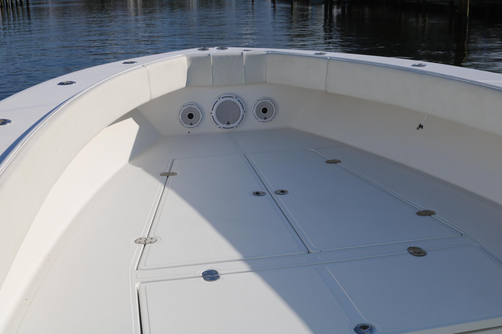 2008 Venture 39 Center Console boat deck with storage compartments and speakers.
