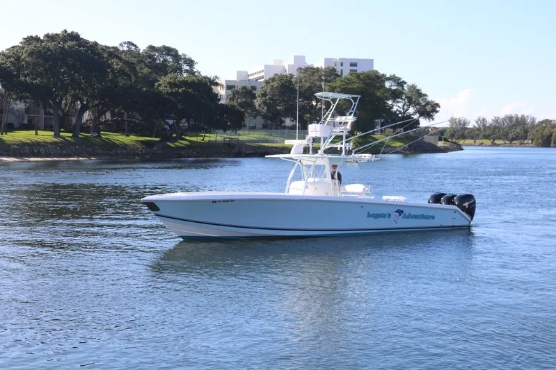 Logan's Adventure Yacht Photos Pics 2008 Venture 39 Center Console boat cruising on a calm river.