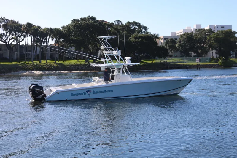 Logan's Adventure Yacht Photos Pics 2008 Venture 39 Center Console boat cruising on a calm river.