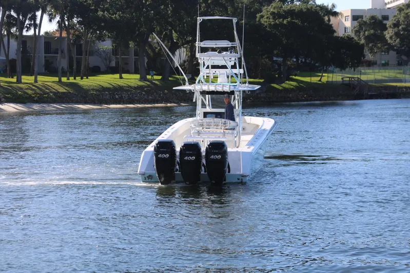 Logan's Adventure Yacht Photos Pics 2008 Venture 39 Center Console boat with triple 400 HP engines on a calm waterway.