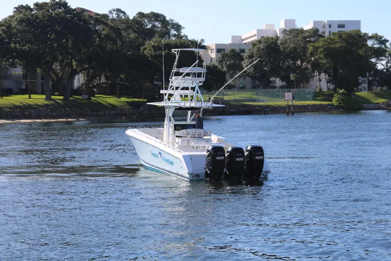 Logan's Adventure Yacht Photos Pics 2008 Venture 39 Center Console boat with triple outboard engines on the water.
