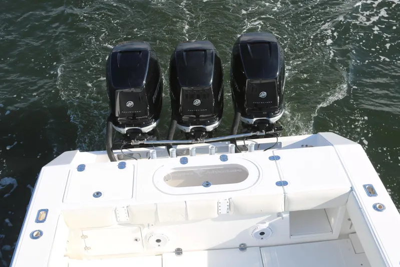 Logan's Adventure Yacht Photos Pics 2008 Venture 39 Center Console with triple outboard engines on water.