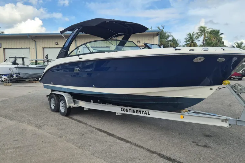  Yacht Photos Pics 2025 Sea Ray SDX 270 Outboard boat on trailer, parked outdoors.