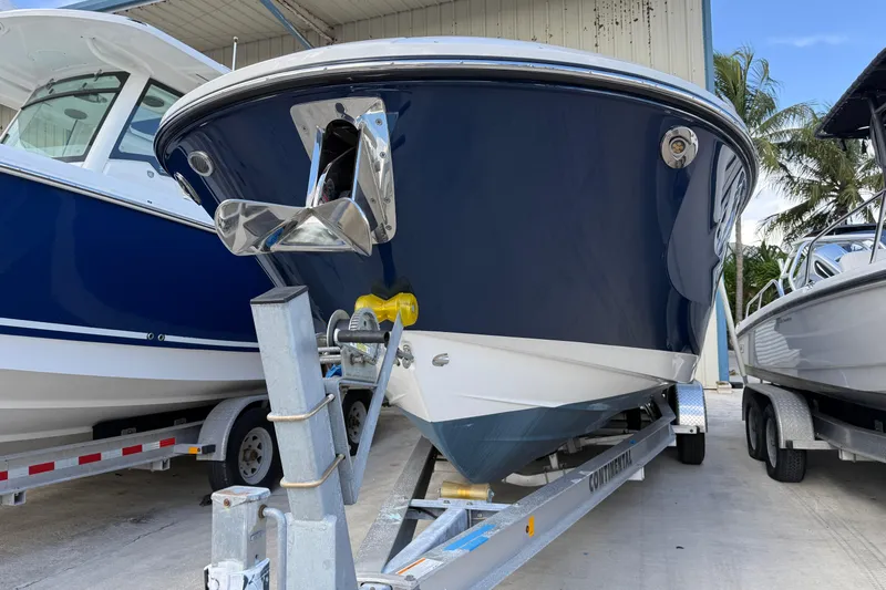  Yacht Photos Pics 2025 Sea Ray SDX 270 Outboard boat on trailer, blue hull, parked outdoors.