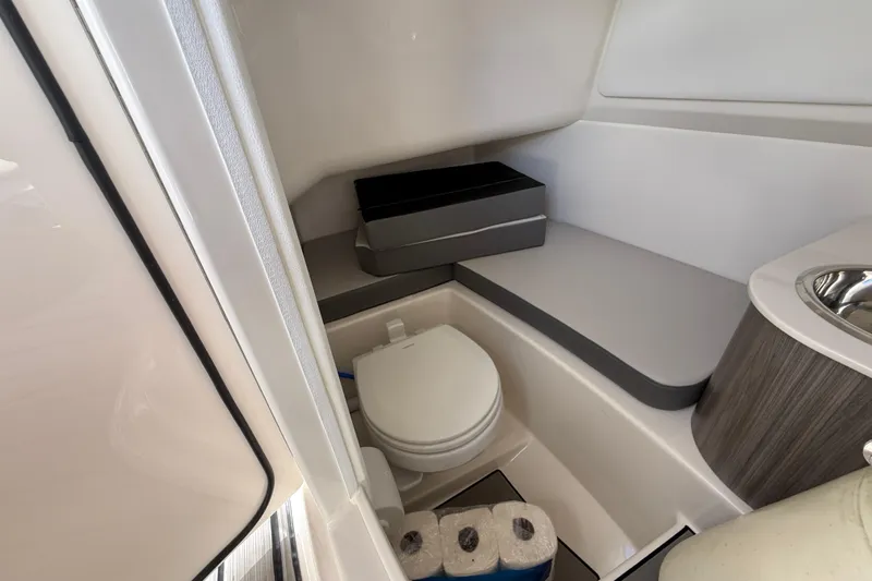  Yacht Photos Pics 2025 Sea Ray SDX 270 Outboard boat interior with compact bathroom amenities.