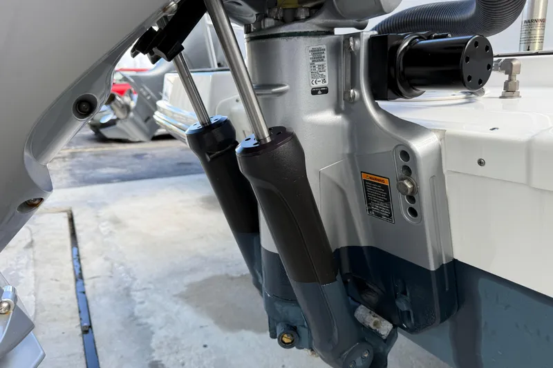  Yacht Photos Pics 2025 Sea Ray SDX 270 Outboard engine detail, showcasing hydraulic components and warning labels.