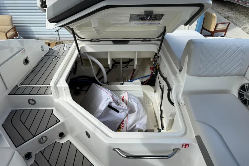  Yacht Photos Pics 2025 Sea Ray SDX 270 Outboard storage compartment with open hatch, showcasing interior details.
