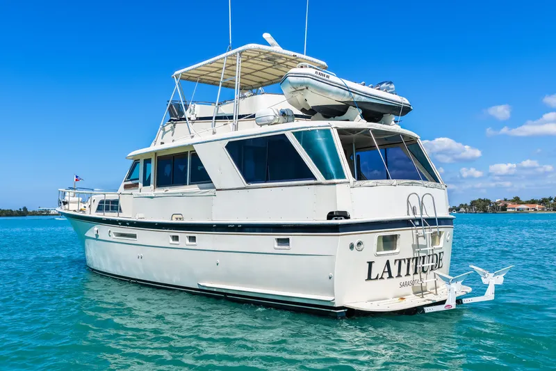 Lattitude Yacht Photos Pics 1979 Hatteras 53 Motor Yacht on clear blue water, sunny day, rear view.