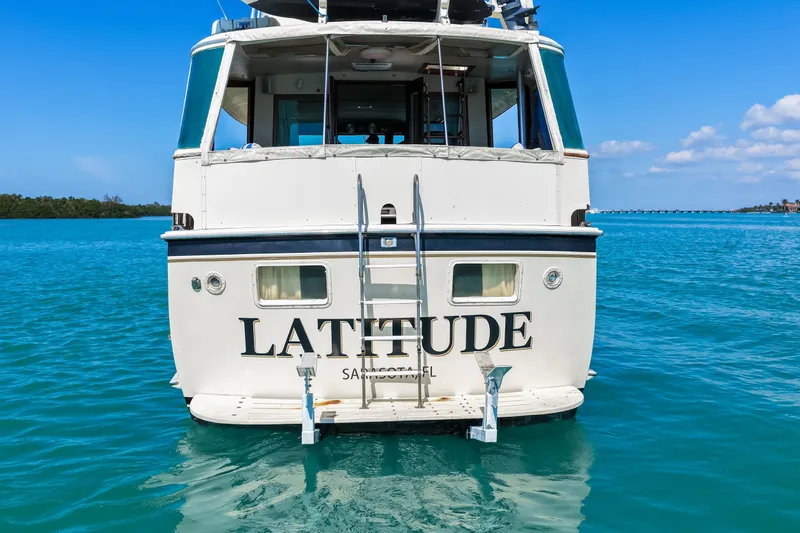 Lattitude Yacht Photos Pics 1979 Hatteras 53 Motor Yacht "Latitude" on clear blue water, rear view.