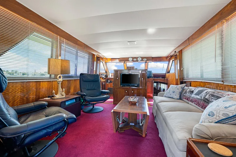 Lattitude Yacht Photos Pics Interior of a 1979 Hatteras 53 Motor Yacht with luxurious seating and decor.