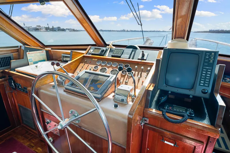 Lattitude Yacht Photos Pics 1979 Hatteras 53 Motor Yacht helm with vintage controls and navigation equipment.