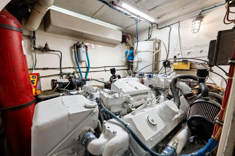 Lattitude Yacht Photos Pics Engine room of a 1979 Hatteras 53 Motor Yacht, showcasing mechanical components.