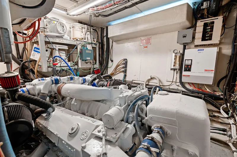 Lattitude Yacht Photos Pics Engine room of a 1979 Hatteras 53 Motor Yacht, showcasing mechanical components and wiring.