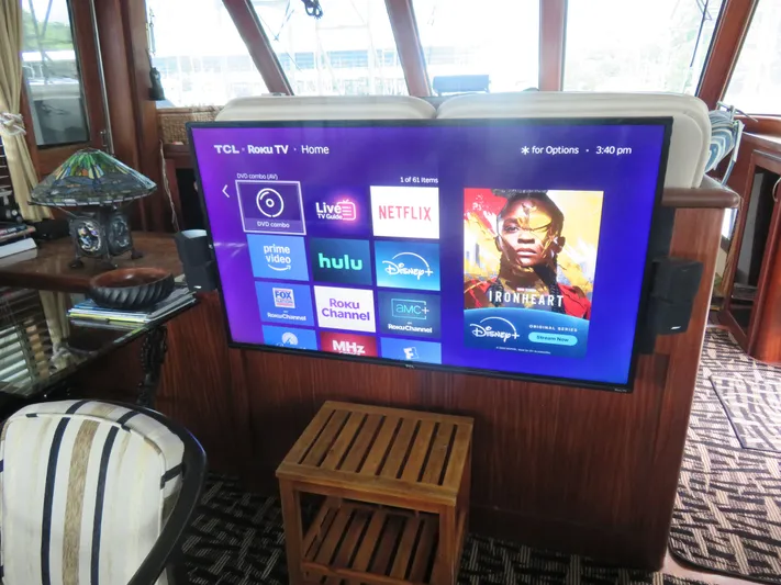 Rive' Gauche Yacht Photos Pics 1986 Hatteras 58 Motor Yacht interior with mounted Roku TV displaying streaming apps.
