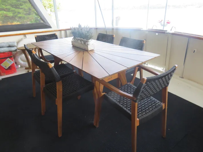 Rive' Gauche Yacht Photos Pics Elegant dining area on 1986 Hatteras 58 Motor Yacht with wooden table and chairs.