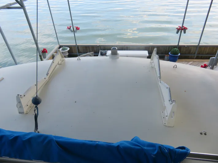 Rive' Gauche Yacht Photos Pics 1986 Hatteras 58 Motor Yacht deck view with water and dockside flowers.