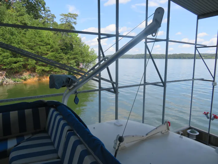 Rive' Gauche Yacht Photos Pics 1986 Hatteras 58 Motor Yacht docked by a scenic lake with lush greenery.
