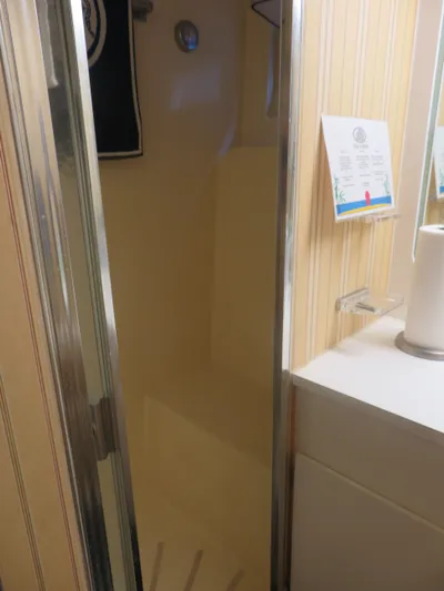 Rive' Gauche Yacht Photos Pics Shower area inside 1986 Hatteras 58 Motor Yacht with striped wallpaper and countertop.