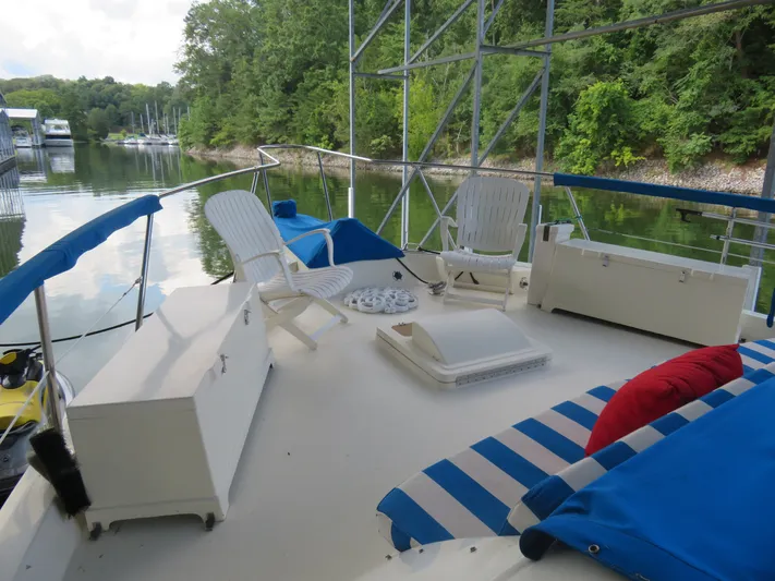 Rive' Gauche Yacht Photos Pics 1986 Hatteras 58 Motor Yacht deck with seating, cushions, and scenic water view.
