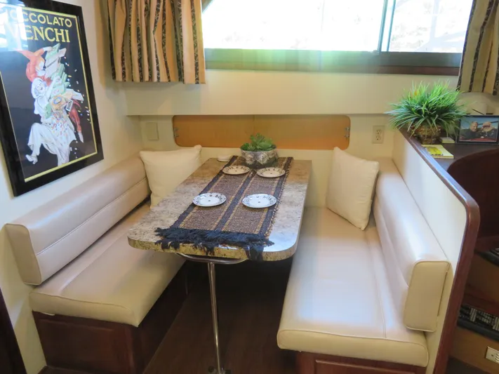 Rive' Gauche Yacht Photos Pics Cozy dining area in 1986 Hatteras 58 Motor Yacht with elegant decor and seating.