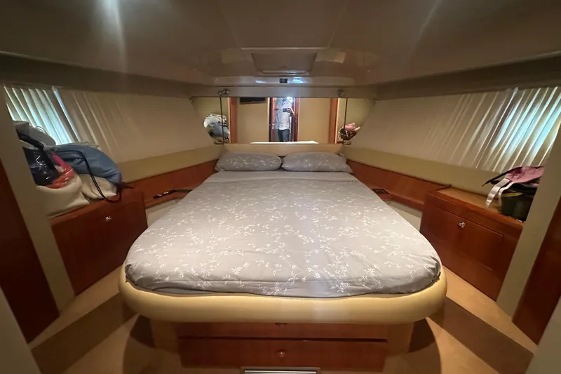  Yacht Photos Pics Luxurious bedroom interior of 2003 Ferretti Yachts 430 with cozy bed and wooden cabinets.