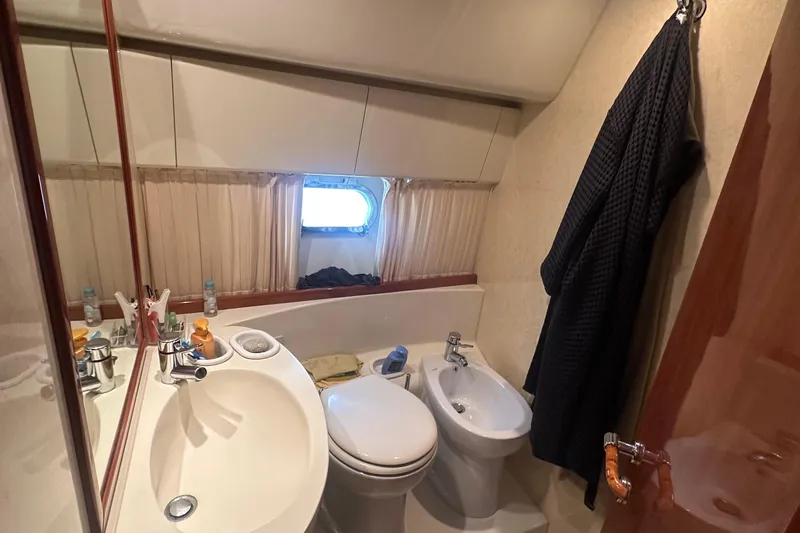  Yacht Photos Pics Bathroom interior of 2003 Ferretti Yachts 430, featuring sink, toilet, and bidet.