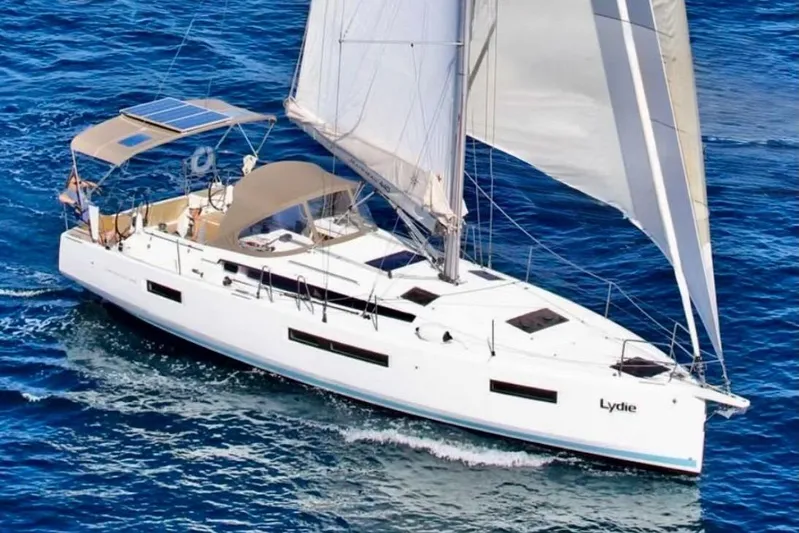  Yacht Photos Pics 2019 Jeanneau Sun Odyssey 440 sailing on open blue sea.