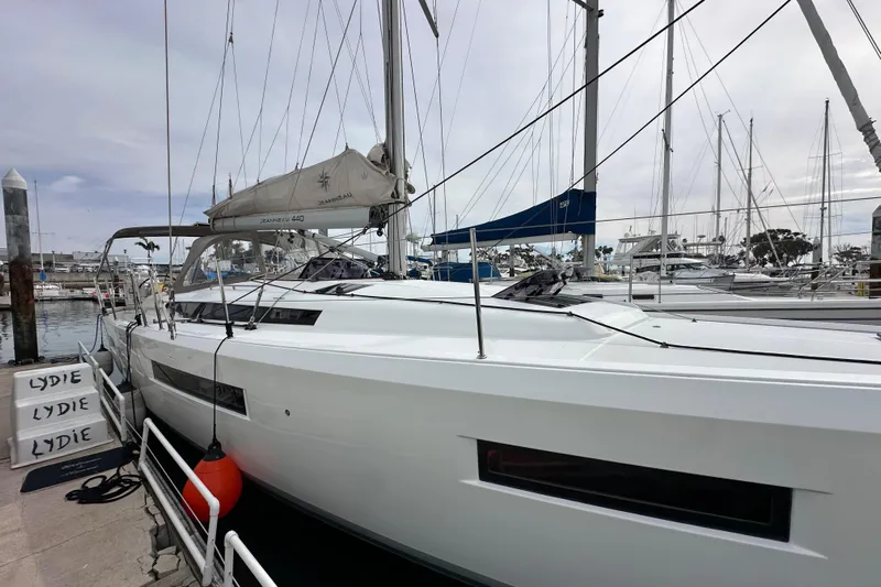  Yacht Photos Pics 2019 Jeanneau Sun Odyssey 440 sailboat docked at marina, overcast sky.
