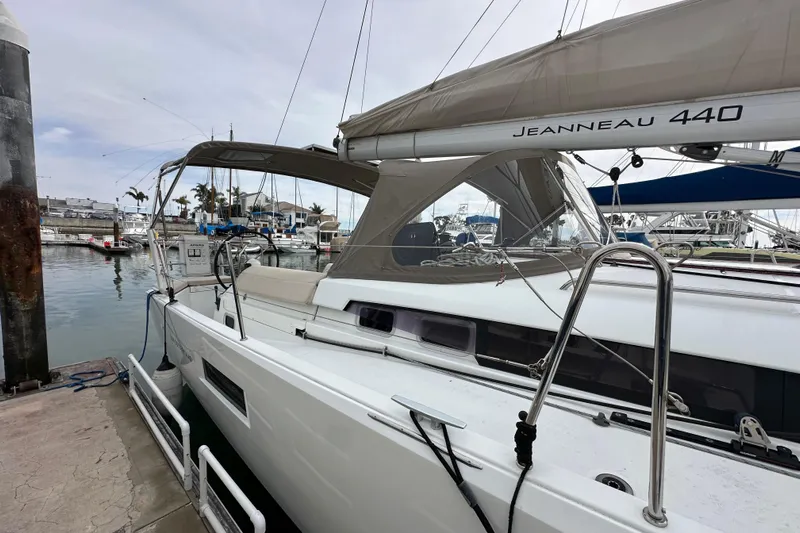  Yacht Photos Pics 2019 Jeanneau Sun Odyssey 440 sailboat docked at marina, side view.