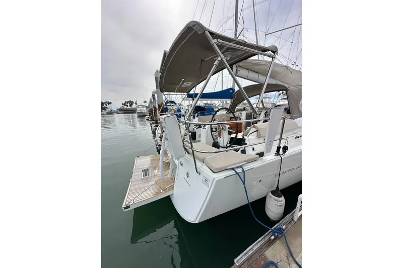  Yacht Photos Pics 2019 Jeanneau Sun Odyssey 440 sailboat docked in a marina, featuring a spacious cockpit.
