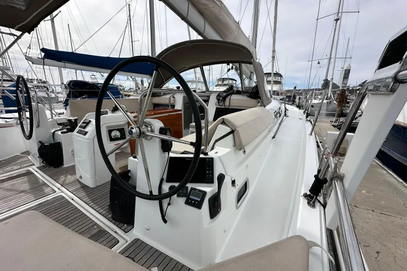  Yacht Photos Pics 2019 Jeanneau Sun Odyssey 440 sailboat cockpit with dual steering wheels in marina.