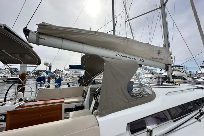  Yacht Photos Pics 2019 Jeanneau Sun Odyssey 440 sailboat docked at marina, featuring sleek design and covered cockpit.
