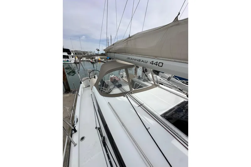  Yacht Photos Pics 2019 Jeanneau Sun Odyssey 440 sailboat docked at marina, showcasing sleek design and sails.