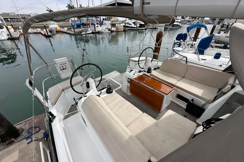  Yacht Photos Pics 2019 Jeanneau Sun Odyssey 440 sailboat cockpit with dual steering wheels, docked in marina.