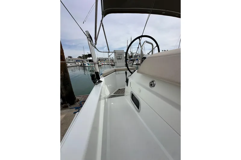  Yacht Photos Pics 2019 Jeanneau Sun Odyssey 440 sailboat cockpit with steering wheel, docked in marina.