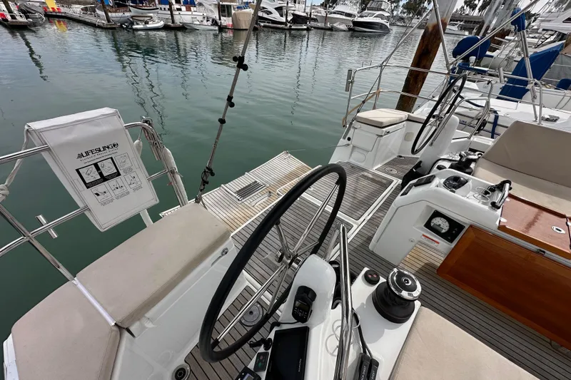  Yacht Photos Pics Cockpit of 2019 Jeanneau Sun Odyssey 440 sailboat, featuring dual steering wheels and marina view.