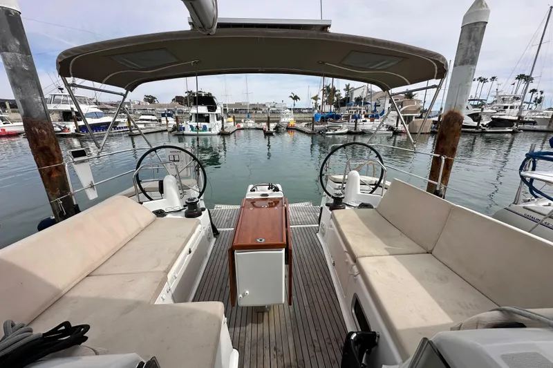  Yacht Photos Pics 2019 Jeanneau Sun Odyssey 440 sailboat interior with dual steering wheels at marina.