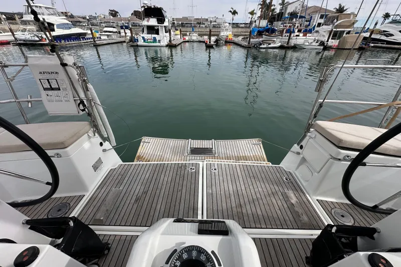  Yacht Photos Pics Jeanneau Sun Odyssey 440 sailboat cockpit view, docked in a marina, 2019 model.