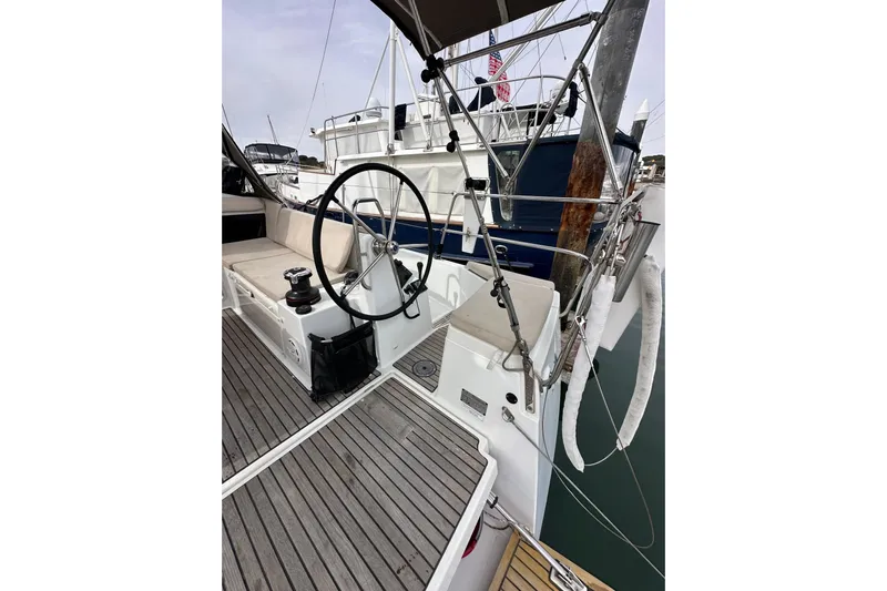  Yacht Photos Pics 2019 Jeanneau Sun Odyssey 440 sailboat cockpit with steering wheel and wooden deck.
