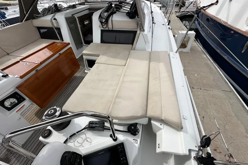  Yacht Photos Pics 2019 Jeanneau Sun Odyssey 440 yacht cockpit with cushioned seating and navigation equipment.