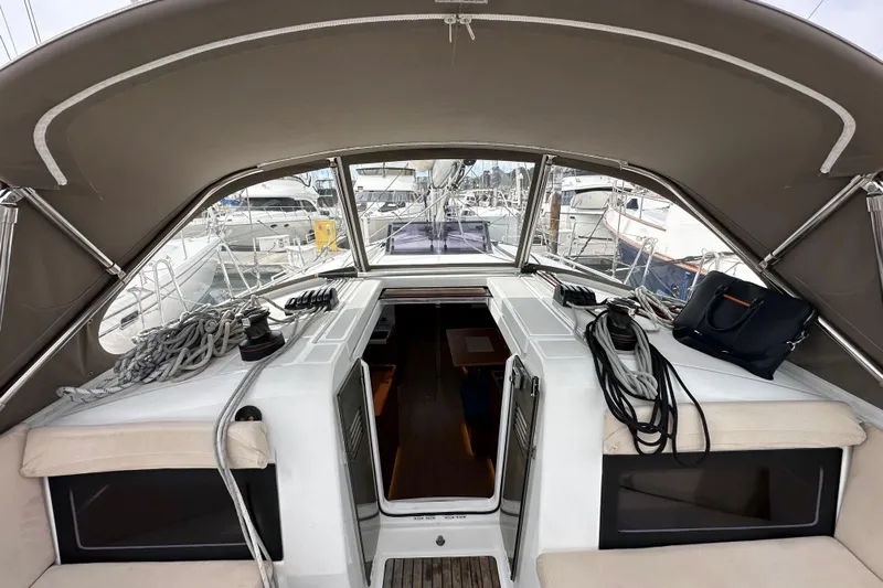  Yacht Photos Pics 2019 Jeanneau Sun Odyssey 440 cockpit with canopy, ropes, and seating in a marina.